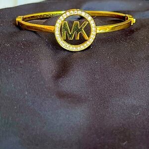 Gold Michael Kors bangle bracelet.